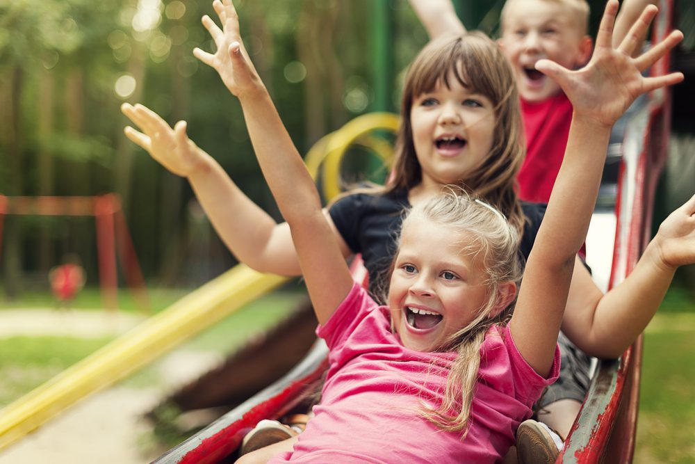 Children enjoying a slide at the playground.